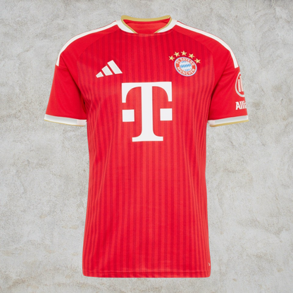 Malvros Bayern Munich red performance soccer jersey with white sponsor logo, club crest, and moisture-wicking fabric.
