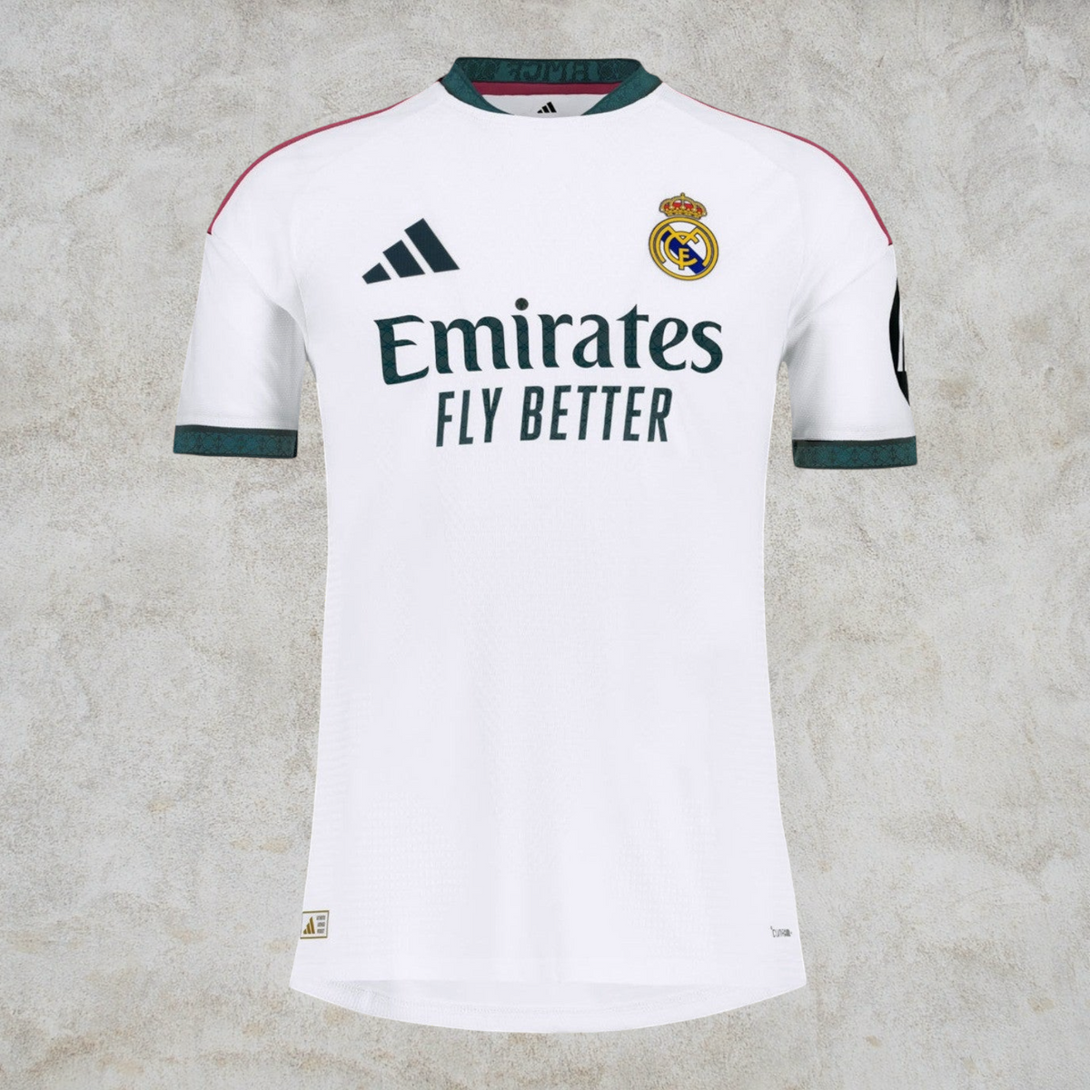 Malvros Real Madrid white performance soccer jersey with dark green accents, club crest, and sponsor logo.