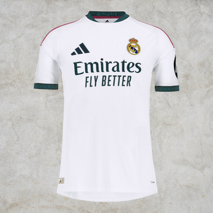 Malvros Real Madrid white performance soccer jersey with dark green accents, club crest, and sponsor logo.